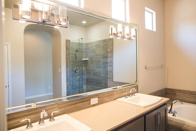 Large minimalist master beige tile bathroom photo in Los Angeles with a drop-in sink, raised-panel cabinets, dark wood cabinets, limestone countertops, a one-piece toilet and gray walls