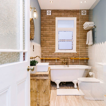 A rustic bathroom with a rolltop bath