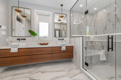 オタワにある広いトランジショナルスタイルのおしゃれなマスターバスルーム (中間色木目調キャビネット、洗面台2つ、フローティング洗面台) の写真
