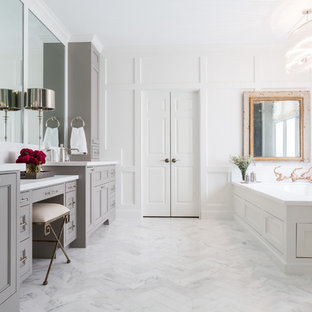 Inspiration for a transitional master white floor bathroom remodel in Houston with recessed-panel cabinets, gray cabinets, an undermount tub and white walls