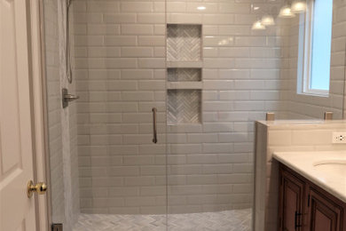 Mid-sized minimalist master gray tile and ceramic tile ceramic tile, beige floor and double-sink bathroom photo in Other with furniture-like cabinets, medium tone wood cabinets, gray walls, an undermount sink, granite countertops, a hinged shower door, white countertops and a freestanding vanity