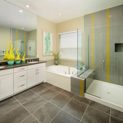 Example of a transitional gray tile and glass tile corner shower design in Phoenix with an undermount sink, shaker cabinets and white cabinets