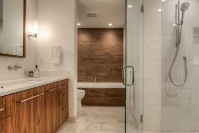 Example of a huge trendy master white tile and ceramic tile porcelain tile bathroom design in Portland with flat-panel cabinets, medium tone wood cabinets, a one-piece toilet, white walls, an undermount sink and quartz countertops