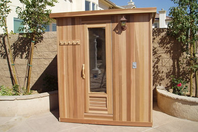 Mid-sized trendy medium tone wood floor and brown floor sauna photo in Los Angeles with brown walls
