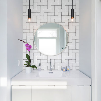 Bathroom - small contemporary master white tile and subway tile marble floor bathroom idea in Toronto with flat-panel cabinets, white cabinets, white walls, an integrated sink and solid surface countertops