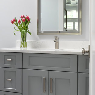 Example of a small beach style kids' ceramic tile, multicolored floor and single-sink toilet room design in Atlanta with flat-panel cabinets, gray cabinets, gray walls, an undermount sink, quartz countertops, yellow countertops and a built-in vanity