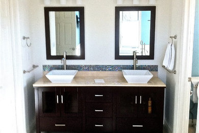 Minimalist gray tile and porcelain tile bathroom photo in Denver with a vessel sink, black cabinets and marble countertops