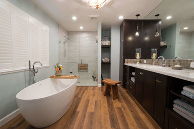 Bathroom - mid-sized craftsman master beige tile and stone tile vinyl floor and brown floor bathroom idea in San Francisco with shaker cabinets, dark wood cabinets, a two-piece toilet, blue walls, an undermount sink, quartz countertops, a hinged shower door and white countertops