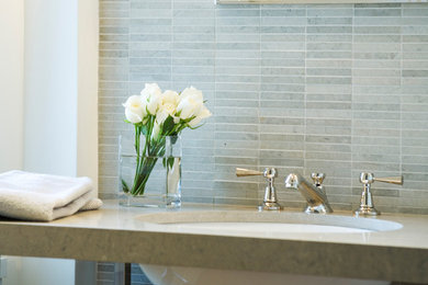 Photo of a medium sized modern ensuite bathroom in New York with grey tiles, stone slabs, white walls and an integrated sink.