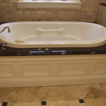 Air bath tub in granite surround.