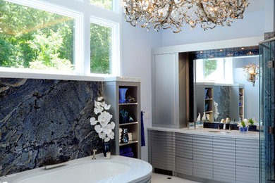 Contemporary bathroom in Columbus with a submerged sink, flat-panel cabinets, grey cabinets, a freestanding bath, blue walls and marble flooring.