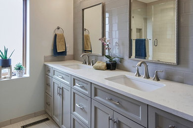 Example of a mid-sized minimalist 3/4 gray tile and subway tile porcelain tile and white floor bathroom design in Portland with shaker cabinets, gray cabinets, white walls, an undermount sink, solid surface countertops and a hinged shower door