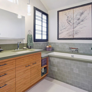 Inspiration for a contemporary bathroom in San Francisco with an undermount sink, flat-panel cabinets, medium wood cabinets, an undermount tub, gray tile and green benchtops.