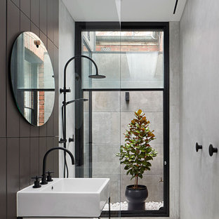 Inspiration for a contemporary 3/4 bathroom in Sydney with open cabinets, a curbless shower, black tile, an integrated sink, white floor, an open shower and white benchtops.
