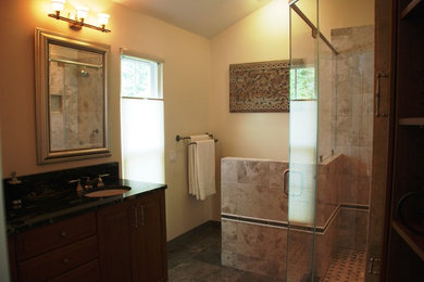 Mid-sized elegant master beige tile and porcelain tile porcelain tile corner shower photo in DC Metro with dark wood cabinets, an undermount sink, raised-panel cabinets, a two-piece toilet, yellow walls and granite countertops