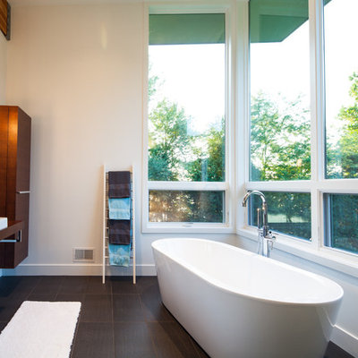 Trendy freestanding bathtub photo in Grand Rapids with a vessel sink