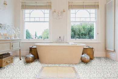 Inspiration for a contemporary master cement tile floor and multicolored floor freestanding bathtub remodel in Dallas with gray walls