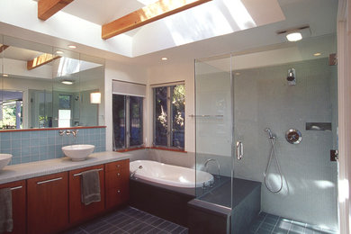 Inspiration for a large contemporary master blue tile and glass tile limestone floor bathroom remodel in Toronto with a vessel sink, flat-panel cabinets, medium tone wood cabinets, quartz countertops, a one-piece toilet and white walls