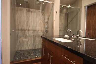 Transitional 3/4 gray tile and pebble tile ceramic tile double shower photo in Vancouver with an undermount sink, flat-panel cabinets, dark wood cabinets, granite countertops, a one-piece toilet and white walls