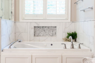 Example of a mid-sized transitional master white tile and porcelain tile porcelain tile, gray floor and double-sink bathroom design in Columbus with shaker cabinets, gray cabinets, gray walls, an undermount sink, granite countertops, multicolored countertops and a niche