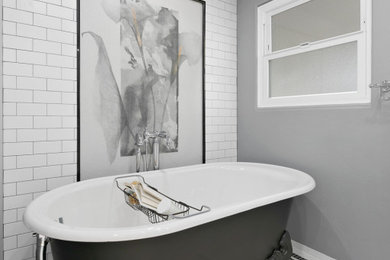 Example of a large classic master white tile white floor and double-sink claw-foot bathtub design in San Diego with shaker cabinets, white cabinets, white walls, a drop-in sink, a hinged shower door and a freestanding vanity