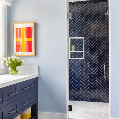 Example of a mid-sized farmhouse kids' blue tile alcove shower design in New York with shaker cabinets, blue cabinets, blue walls, a hinged shower door and white countertops