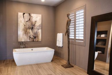 Large trendy master porcelain tile and beige floor bathroom photo in Other with flat-panel cabinets, black cabinets, gray walls, a vessel sink, granite countertops, a hinged shower door and black countertops