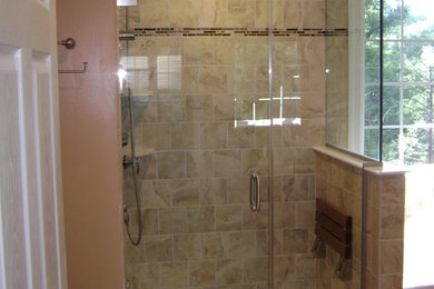Example of a mid-sized master brown tile and porcelain tile porcelain tile bathroom design in New York with shaker cabinets, black cabinets, a two-piece toilet, brown walls, an undermount sink and granite countertops