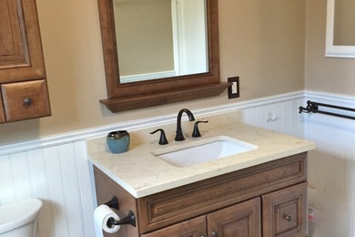Bathroom - mid-sized eclectic 3/4 white tile and porcelain tile porcelain tile bathroom idea in Baltimore with raised-panel cabinets, dark wood cabinets, a two-piece toilet, beige walls, an undermount sink and laminate countertops