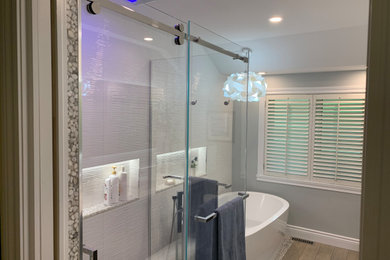 Bathroom - large contemporary master white tile and porcelain tile porcelain tile, gray floor and double-sink bathroom idea in Montreal with flat-panel cabinets, brown cabinets, a one-piece toilet, gray walls, an undermount sink, quartz countertops, white countertops, a niche and a floating vanity