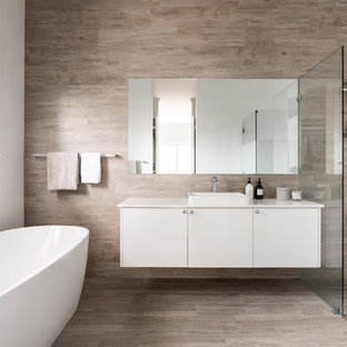 Contemporary master bathroom in Perth with flat-panel cabinets, white cabinets, a freestanding tub, a curbless shower, gray tile, a vessel sink, grey floor and white benchtops.