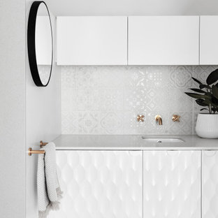 Inspiration for a mid-sized contemporary bathroom in Melbourne with white cabinets, white tile, white walls, an undermount sink, white benchtops, a single vanity and a built-in vanity.