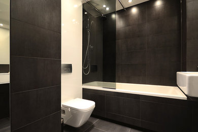 Example of a large minimalist master white tile and terra-cotta tile terra-cotta tile tub/shower combo design in Other with a drop-in sink, glass-front cabinets, a one-piece toilet and black walls