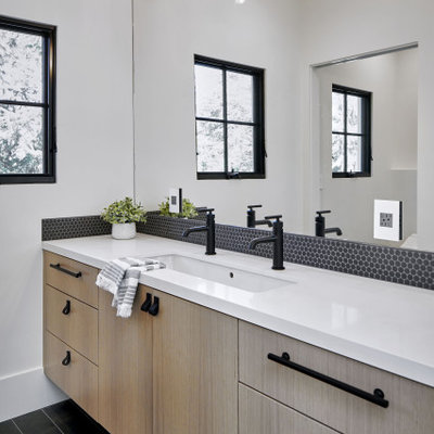 Inspiration for a mid-sized contemporary master black tile and mosaic tile black floor bathroom remodel in San Francisco with flat-panel cabinets, light wood cabinets, white walls, an undermount sink, white countertops and a floating vanity