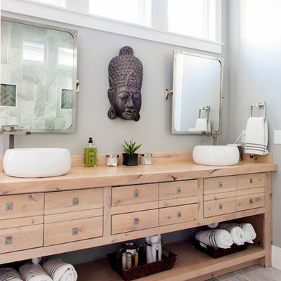 Inspiration for a mid-sized master gray tile and porcelain tile porcelain tile and gray floor doorless shower remodel in Birmingham with gray walls, flat-panel cabinets, light wood cabinets, a vessel sink, a one-piece toilet, wood countertops and brown countertops