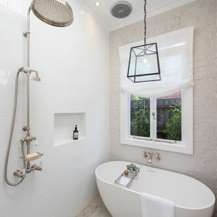 Inspiration for a contemporary white tile and ceramic tile porcelain tile, beige floor and brick wall bathroom remodel in Melbourne with white walls