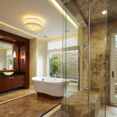 Example of a large trendy master brown tile and marble tile marble floor bathroom design in Miami with a vessel sink, dark wood cabinets, a one-piece toilet, beige walls, granite countertops and flat-panel cabinets