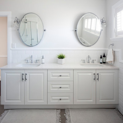 Inspiration for a large timeless master white tile and ceramic tile gray floor bathroom remodel in Brisbane with white cabinets, white walls, an undermount sink, quartz countertops, white countertops and raised-panel cabinets