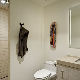 Mid-sized minimalist 3/4 bathroom photo in Denver with flat-panel cabinets and beige cabinets
