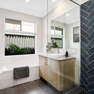 Photo of a mid-sized contemporary master bathroom in Perth with flat-panel cabinets, medium wood cabinets, a corner shower, black tile, porcelain tile, grey walls, porcelain floors, a vessel sink, grey floor, grey benchtops, a single vanity and a built-in vanity.