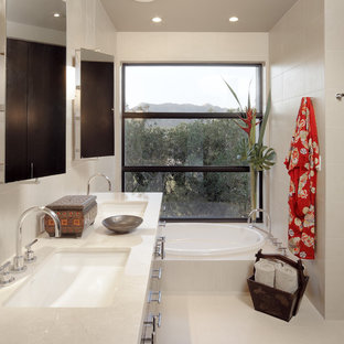 Inspiration for a zen beige tile drop-in bathtub remodel in Phoenix with an undermount sink