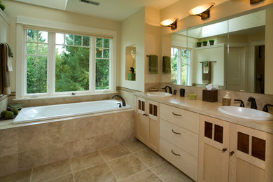Large elegant master beige tile and ceramic tile ceramic tile and beige floor bathroom photo in Portland with shaker cabinets, light wood cabinets, a two-piece toilet, beige walls, a drop-in sink, tile countertops and a hinged shower door