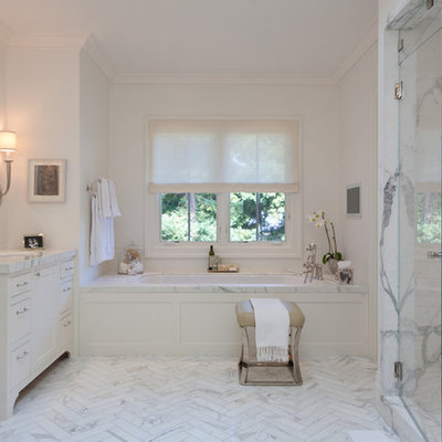 Example of a large trendy white tile and marble tile marble floor alcove shower design in San Francisco with an undermount sink, white cabinets, marble countertops, an undermount tub and white walls