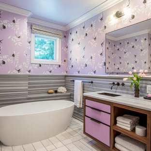 Contemporary kids bathroom in San Francisco with purple cabinets, a freestanding tub, gray tile, an undermount sink, grey benchtops, a double vanity, a built-in vanity and wallpaper.