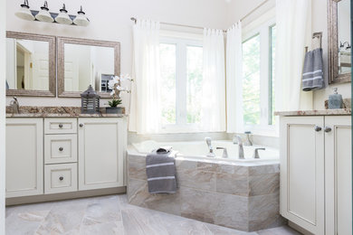Corner bathtub - large traditional master gray tile and ceramic tile gray floor corner bathtub idea in Atlanta with recessed-panel cabinets, white cabinets, gray walls, an undermount sink, granite countertops and gray countertops