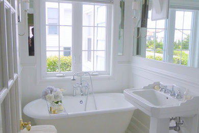 Freestanding bathtub - small transitional master marble floor and white floor freestanding bathtub idea in New York with raised-panel cabinets, white cabinets, a one-piece toilet, white walls and a pedestal sink