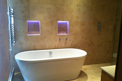 Photo of a modern bathroom in Other with a freestanding bath.