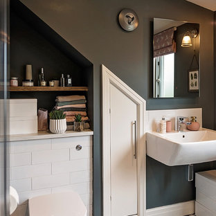Small contemporary ensuite bathroom in Other with white tiles, porcelain tiles, grey walls, porcelain flooring, open cabinets, a one-piece toilet, a wall-mounted sink and multi-coloured floors.