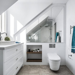 Photo of a mid-sized contemporary bathroom in Sydney with shaker cabinets, white cabinets, a one-piece toilet, white tile, ceramic tile, white walls, a vessel sink, brown floor and beige benchtops.
