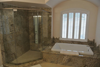 Large minimalist master gray tile and stone slab ceramic tile and beige floor bathroom photo in Sacramento with shaker cabinets, gray cabinets, a bidet, beige walls, a drop-in sink, granite countertops and a hinged shower door